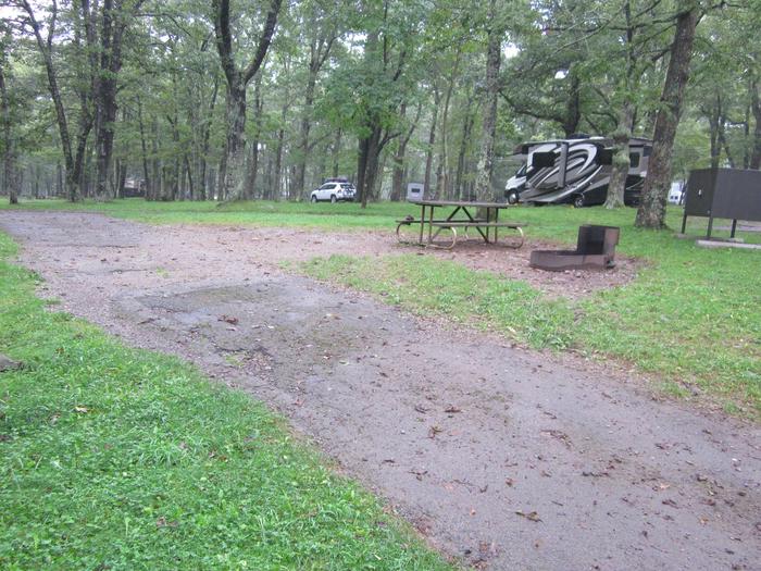 Campsite I221Site has a driveway, tent pad, picnic table, fire pit, and food storage box. 