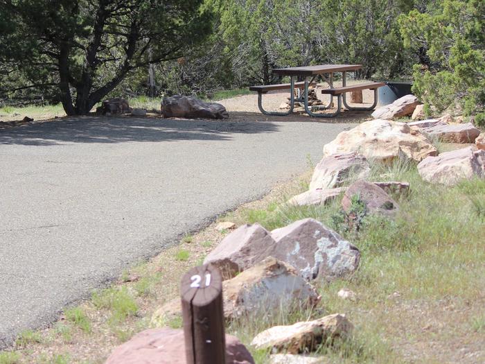 Picnic table and fire pit in a gravel area at the end of the parking area for this site. Site identifier is found at the beginning of the parking area of this site.Cedar Springs Campground: Site 21