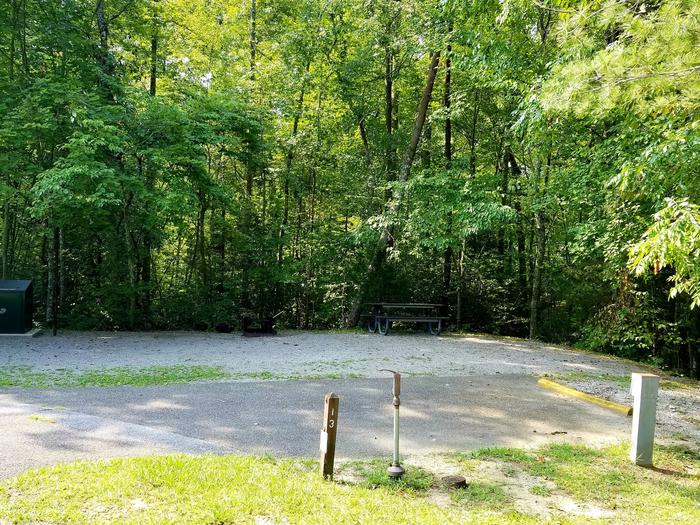 Paved parking spot next to gravel tent pad and picnic table.Blue Heron Campground Site 13