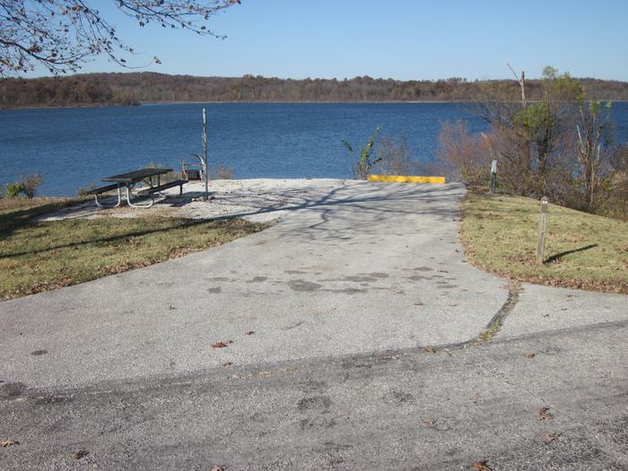 Electric site with paved/gravel pad, picnic table, fire ring, lantern post, and great lake frontage.Ruark West site 20