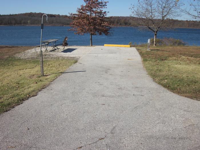 Electric site with paved/gravel pad, picnic table, fire ring, lantern post, and great lake frontage.Ruark West site 23