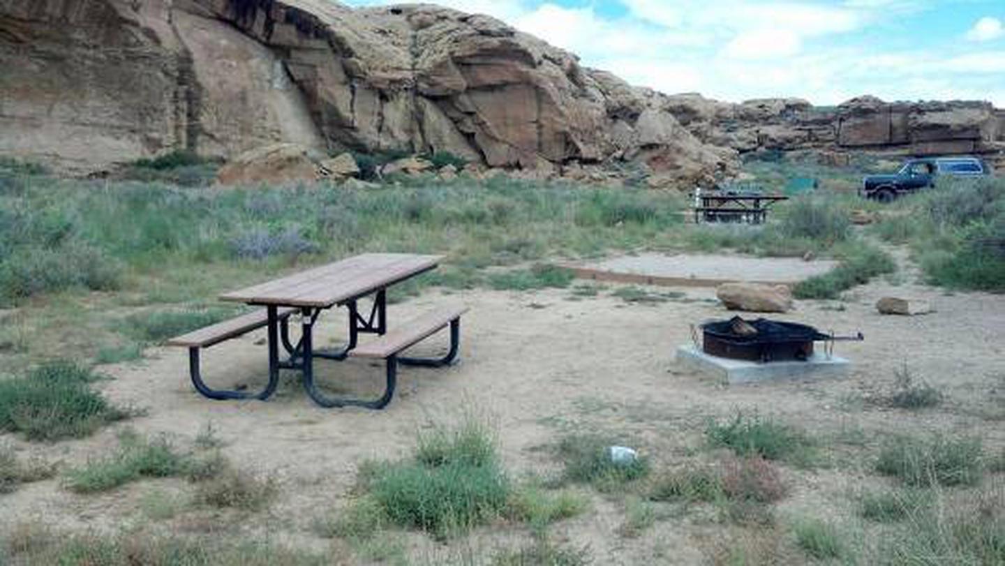 Campsite 25View of picnic table, fire grate and tent pad with canyon wall in background