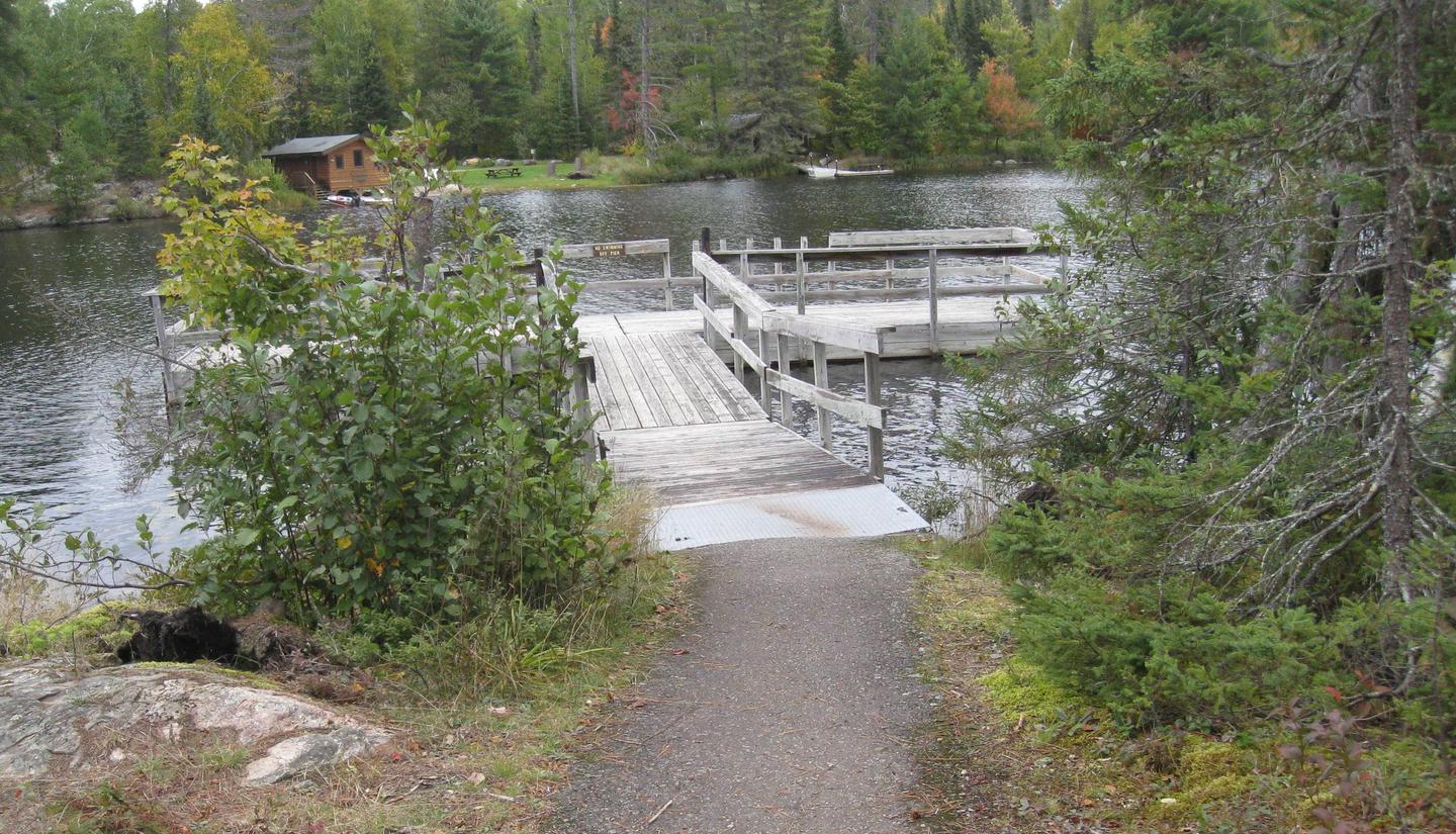 Picture of trail and fishing pier.Paved trail accessing fishing pier.