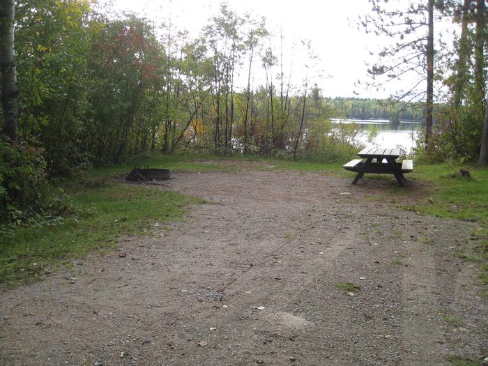 Picture of camping spur with table and fire ring.Typical back-in campsite with table and fire ring.  Site provides direct access to the lake.