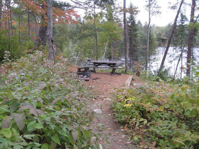 Picture of campsite.Campsite with table, fire ring and tent pad, overlooking Fenske Lake.