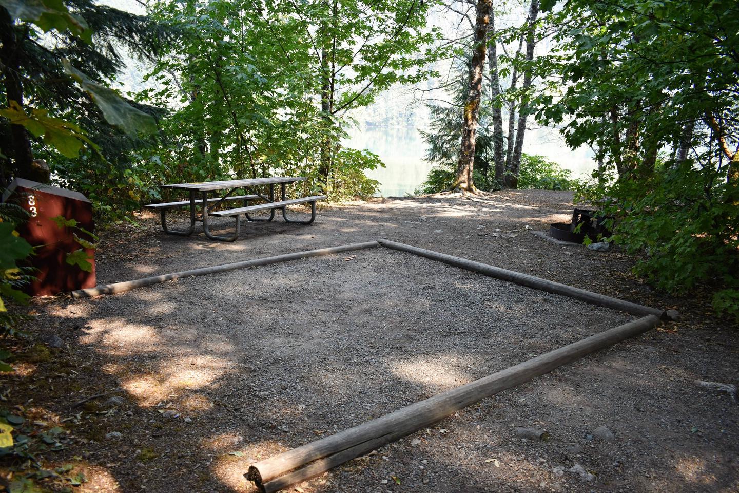 Food storage locker, picnic table, tent pad, and fire ringView of campsite