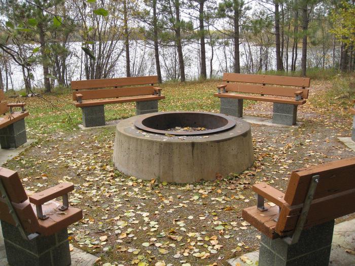 Picture of fire ring and benches.Group campsite with table, fire ring, and tent pad.
