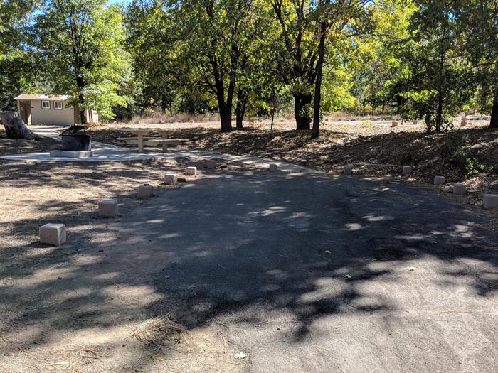 Burnt Rancheria Campground Site #12 featuring entrance to the wooded site and camping space.
