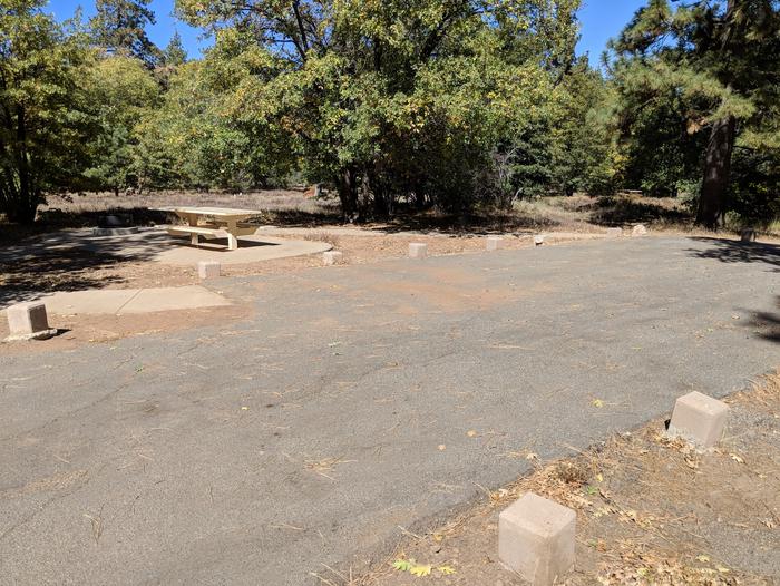 Burnt Rancheria Campground Site #14 featuring entrance to the wooded site and camping space. 