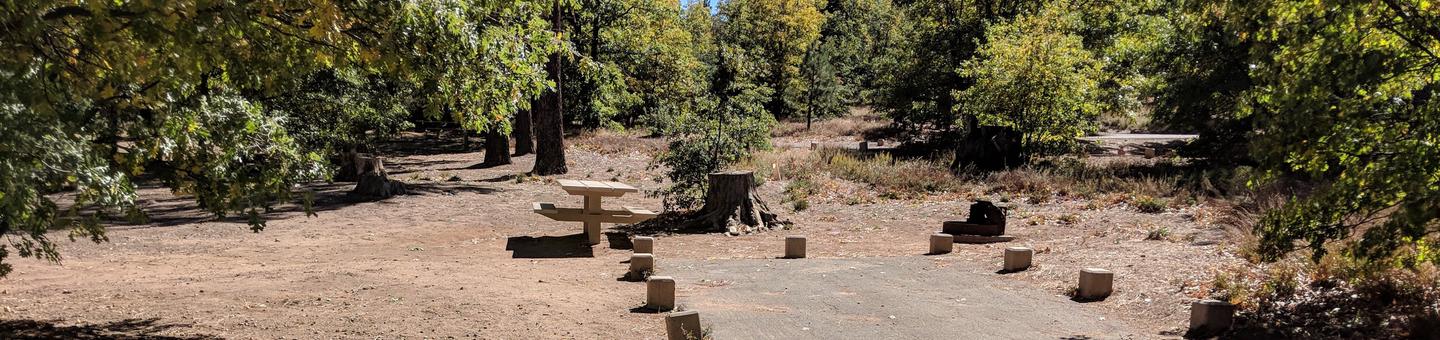 Burnt Rancheria Campground Site #16 featuring entrance to the wooded site and camping space. 