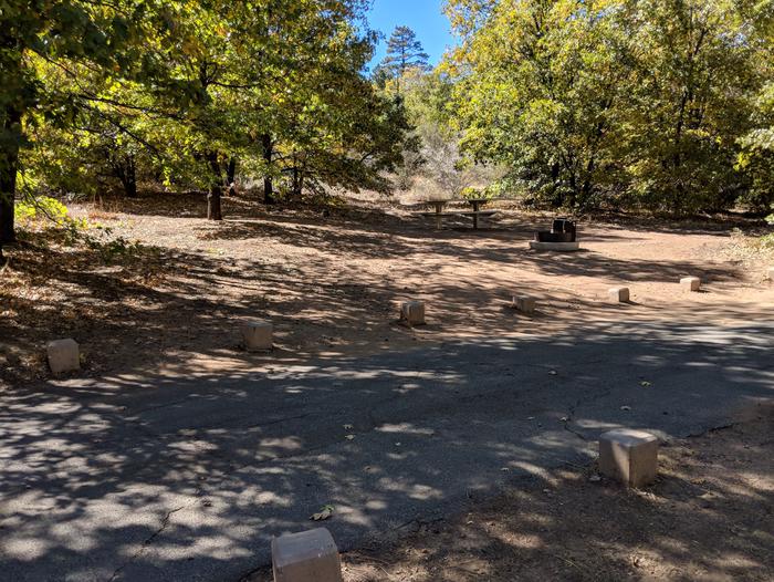 Burnt Rancheria Campground Site #29 featuring entrance to the wooded site and camping space. 