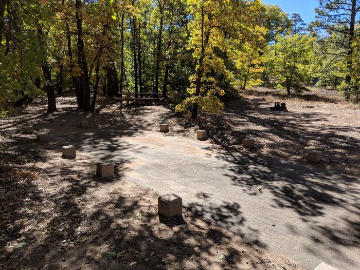 Burnt Rancheria Campground Site #32 featuring entrance to the wooded site and camping space.