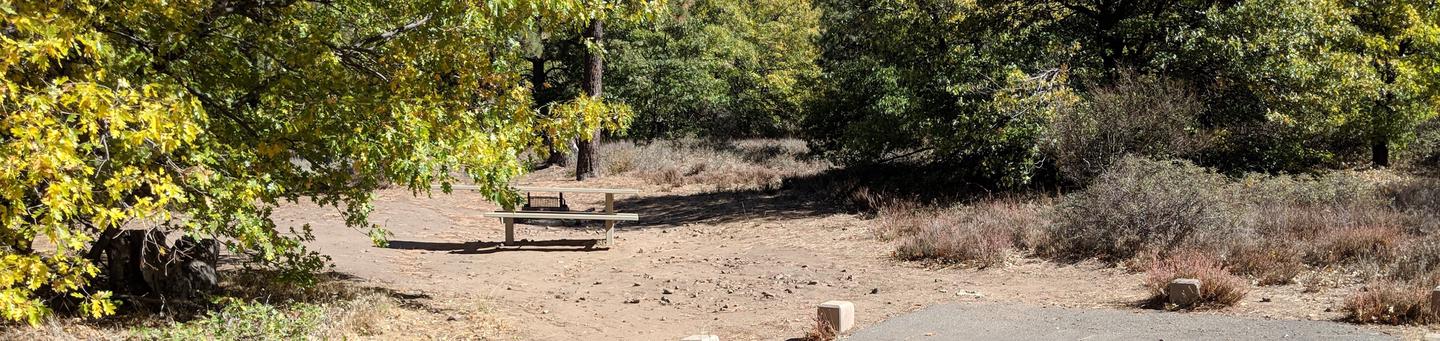 Burnt Rancheria Campground Site #53 featuring entrance to the wooded site and picnic table.