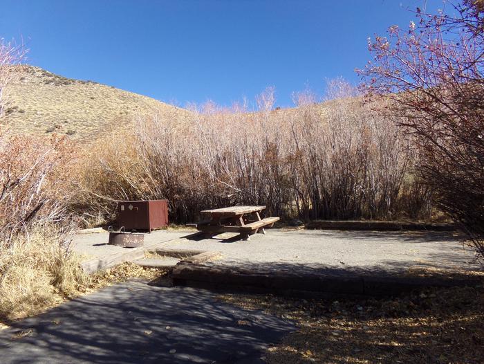 Convict Lake Campground site #63 featuring picnic table, food storage, and fire pit.