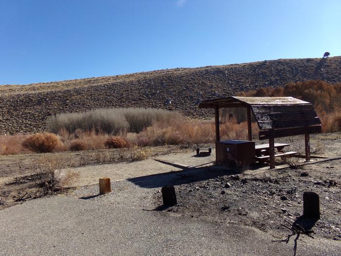 McGee Creek Campground site #06 featuring shaded picnic area with fire pit and camping space. 