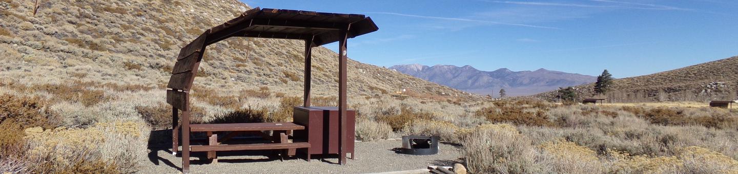 McGee Creek Campground site #13 featuring shaded picnic area with fire pit and camping space. 