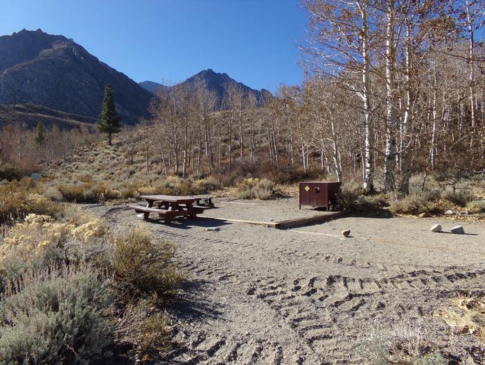 McGee Creek Campground site #25 full campsite view with picnic area, food storage, and fire pit. 