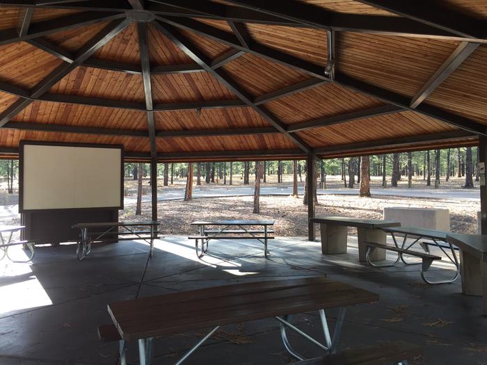 O'Leary Group Campground Site #03 ramada with multiple picnic tables and projector screen.