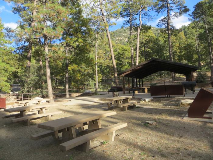 Rose Canyon Campground Group Site featuring ramada covered picnic and uncovered picnic areas among the trees. 
