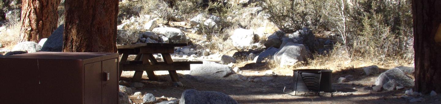 Mt. Whitney Portal Campground site #23 featuring the mountain top setting picnic area with fire pit. 