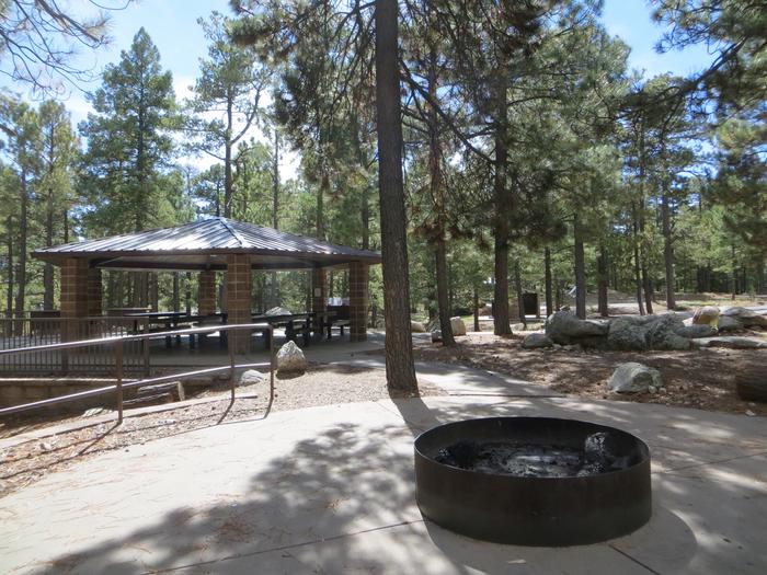 Whitetail Campground Group Site #04 featuring large ramada with multiple picnic tables, fire pit, and food storage. 