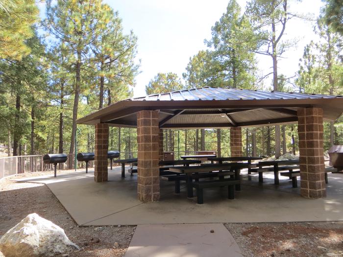 Whitetail Campground Group Site #04 featuring large ramada with multiple picnic tables and food storage. 