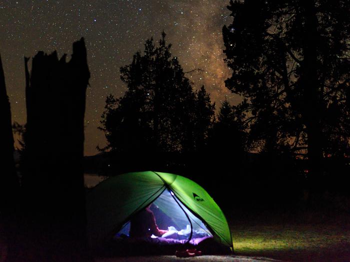 Tent at night with Milky Way overheadNighttime reading in Plumas National Forest