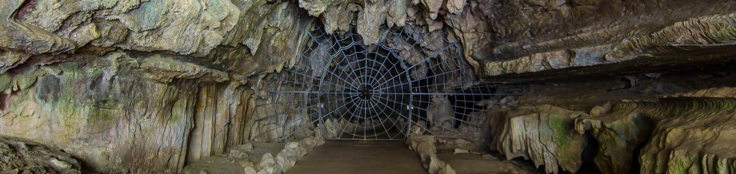 In order to enter Crystal Cave you must first pass through the famous historical Spider Web Gate. The gate was installed in 1939.The Crystal Cave Spider Web Gate. Installed in 1939.