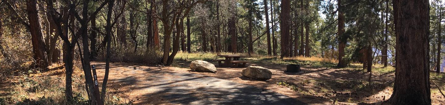 Picnic table, fire pit, and driveway for North Rim Campground, Site 16.