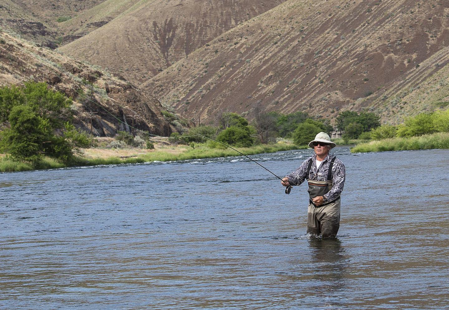A fly fisherman tries his luck on the Deschutes river.A fly fisherman tries his luck on the Deschutes river.
