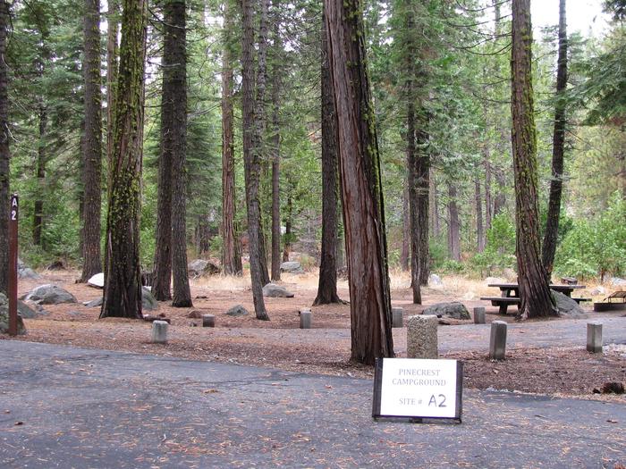 Paved site with picnic table and fire ringPinecrest Campground Site A2