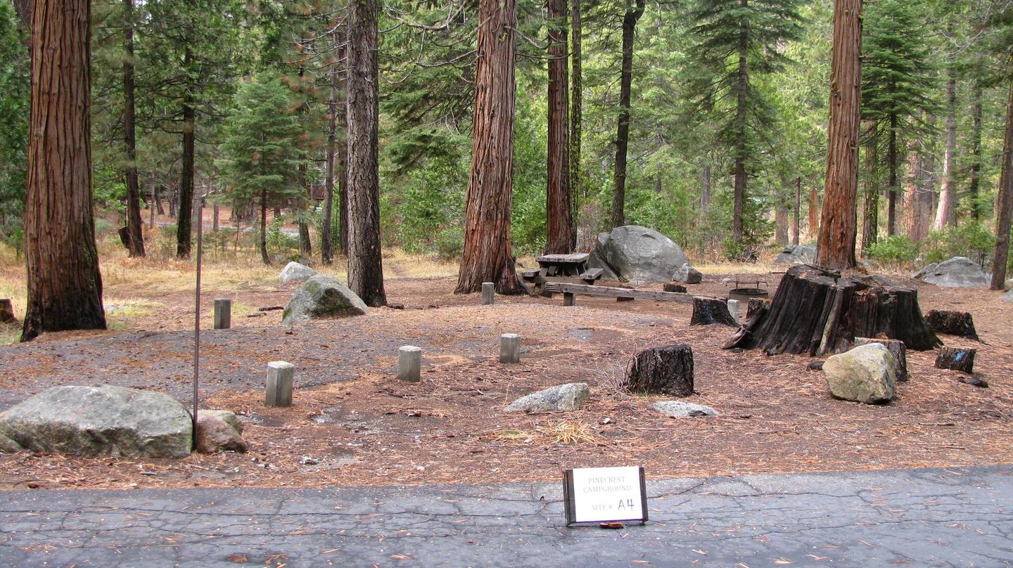 Paved site with picnic table and fire ringPinecrest Campground Site A4