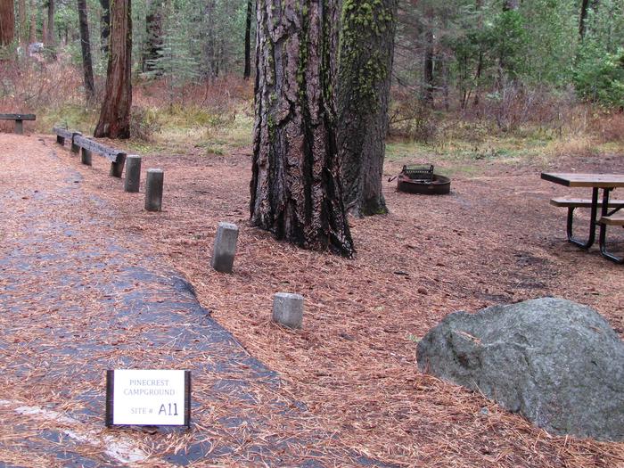 Paved site with picnic table and fire ringPinecrest Campground Site A11