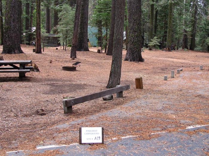 Paved site with picnic table and fire ringPinecrest Campground Site A19