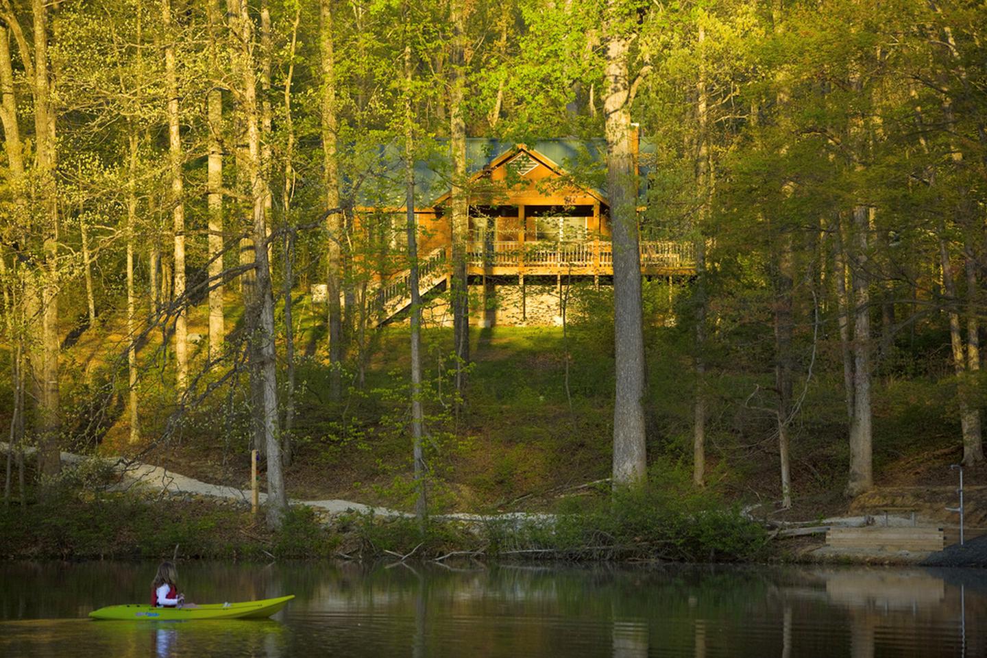 Kayaking with a view of a rental cabin at Bear Creek Lake State Park