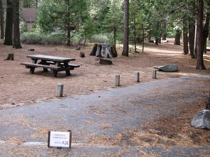 Paved site with picnic table and fire ringPinecrest Campground Site A26