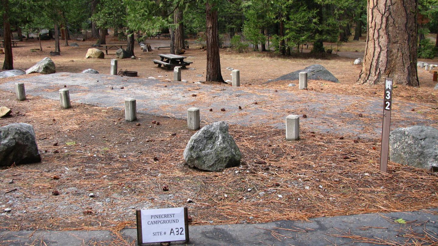 Paved site with picnic table and fire ringPinecrest Campground Site A32