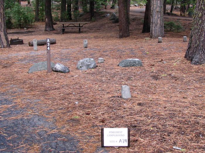 Paved site with picnic table and fire ringPinecrest Campground Site A34