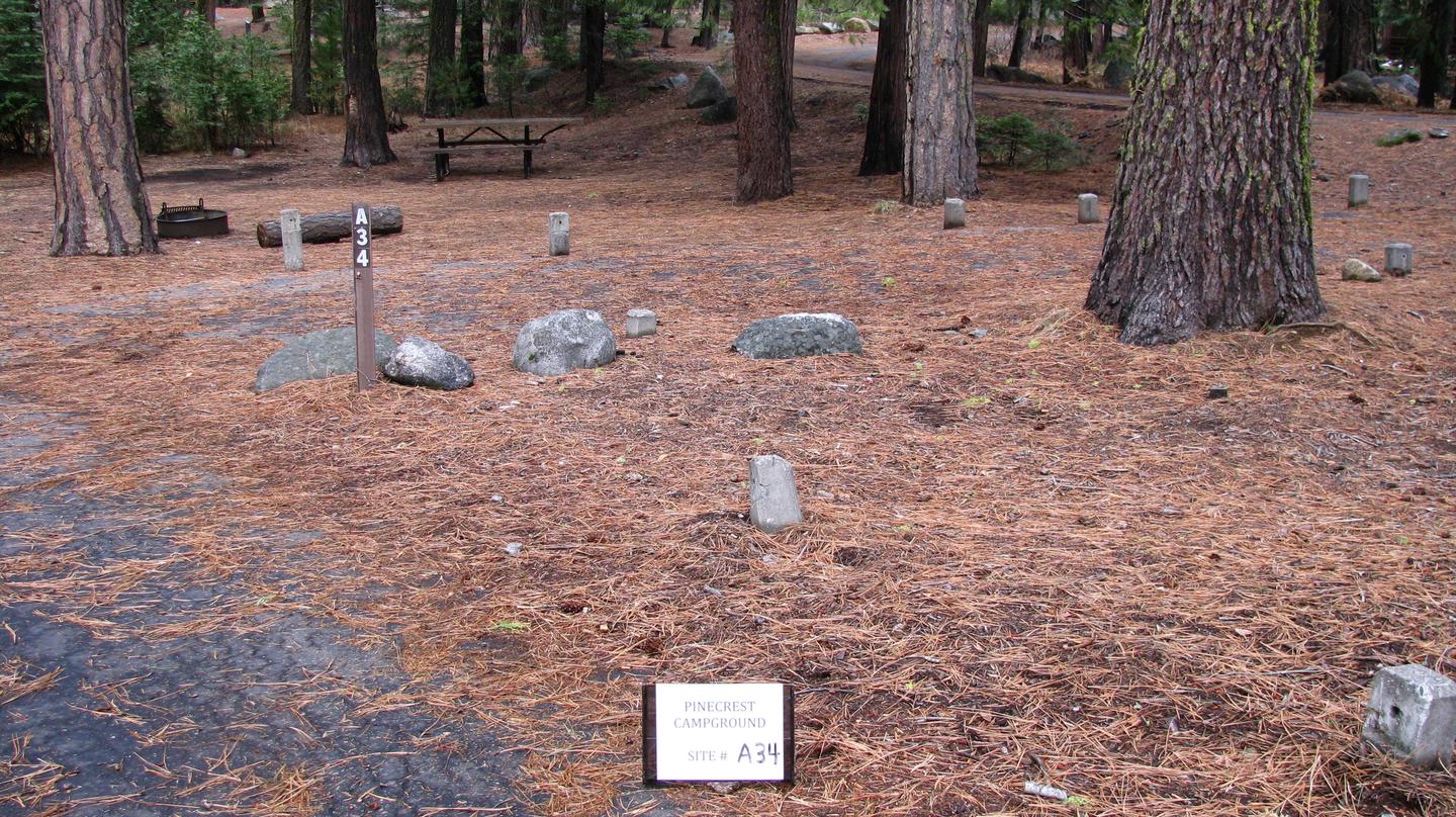 Paved site with picnic table and fire ringPinecrest Campground Site A34