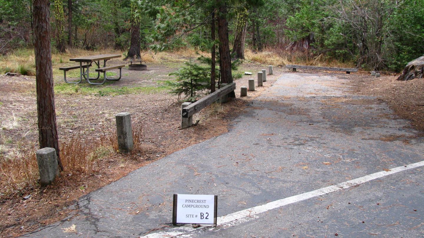 Paved site with picnic table and fire ringPinecrest Campground Site B2