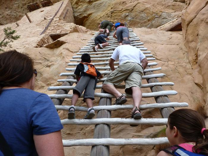 Visitors Climbing To Cliff Dwellings