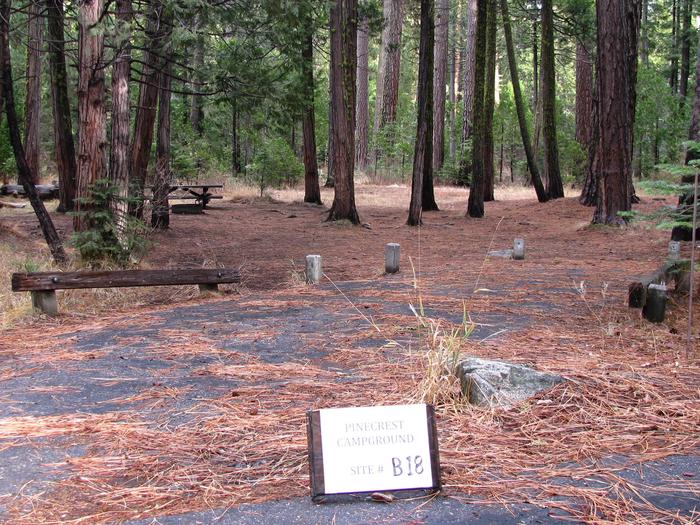 Paved site with picnic table and fire ringPinecrest Campground Site B18