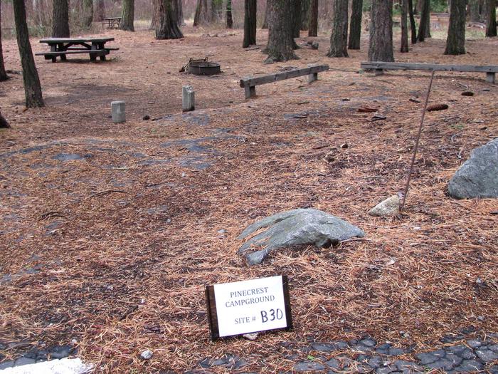 Paved site with picnic table and fire ringPinecrest Campground Site B30