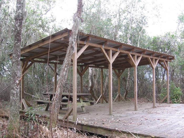 Monkey Lake shelter with trees and shrubs behind itMonkey Lake Shelter (Pink Trail)