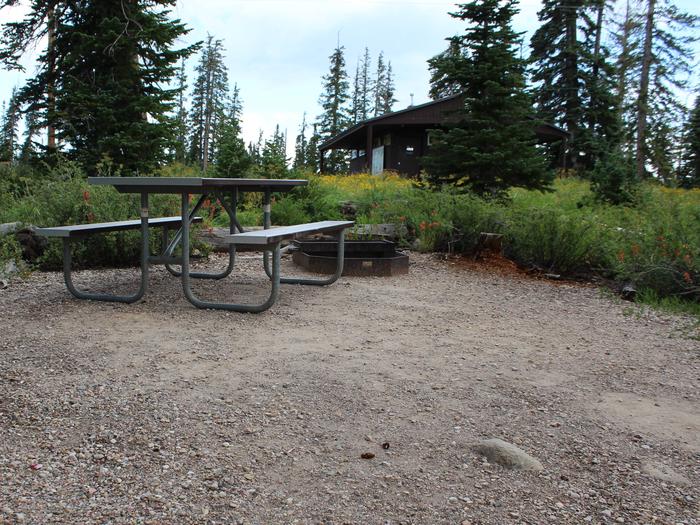 Site 18: Table, fire pit and restroom.