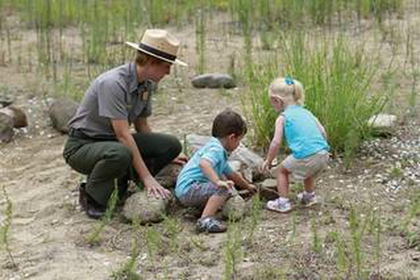 Park ranger with kids in the nature play area at the Paul H Douglas Center area in the Indiana Dunes National Park.