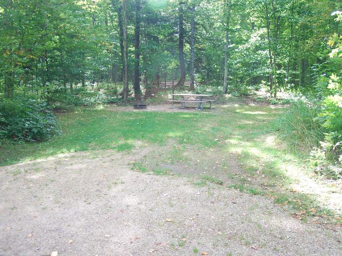 AuTrain Lake Campground site #14 full site view with table, fire pit, and picnic table. 