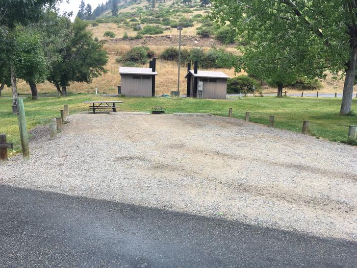 Site 11 BLM Holter Lake Campground. Paved access to campsite. Graveled campsite with picnic table and fire pit. Trees dispersed throughout campground. Near 2 vault toilets.Site 11 BLM Holter Lake Campground.