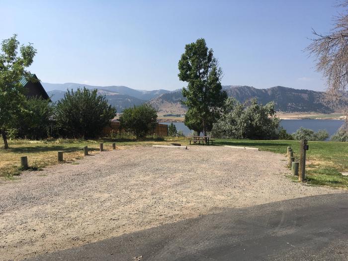 Site 19 BLM Holter Lake Campground. Lakeside campsite. Paved access to campsite. Graveled campsite with picnic table and fire pit. Trees dispersed throughout campground. Adjacent to private land.Site 19 BLM Holter Lake Campground.