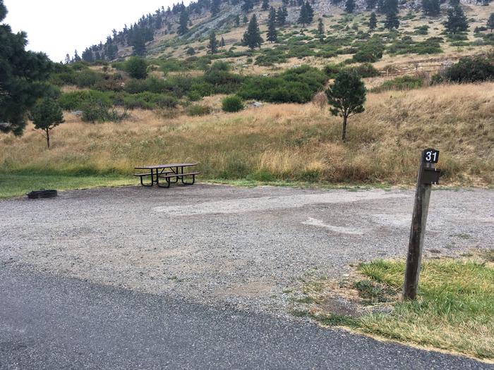 Site 31 BLM Holter Lake Campground. Paved access to campsite. Graveled campsite with picnic table and fire pit. Beartooth Road above campground.Site 31 BLM Holter Lake Campground.